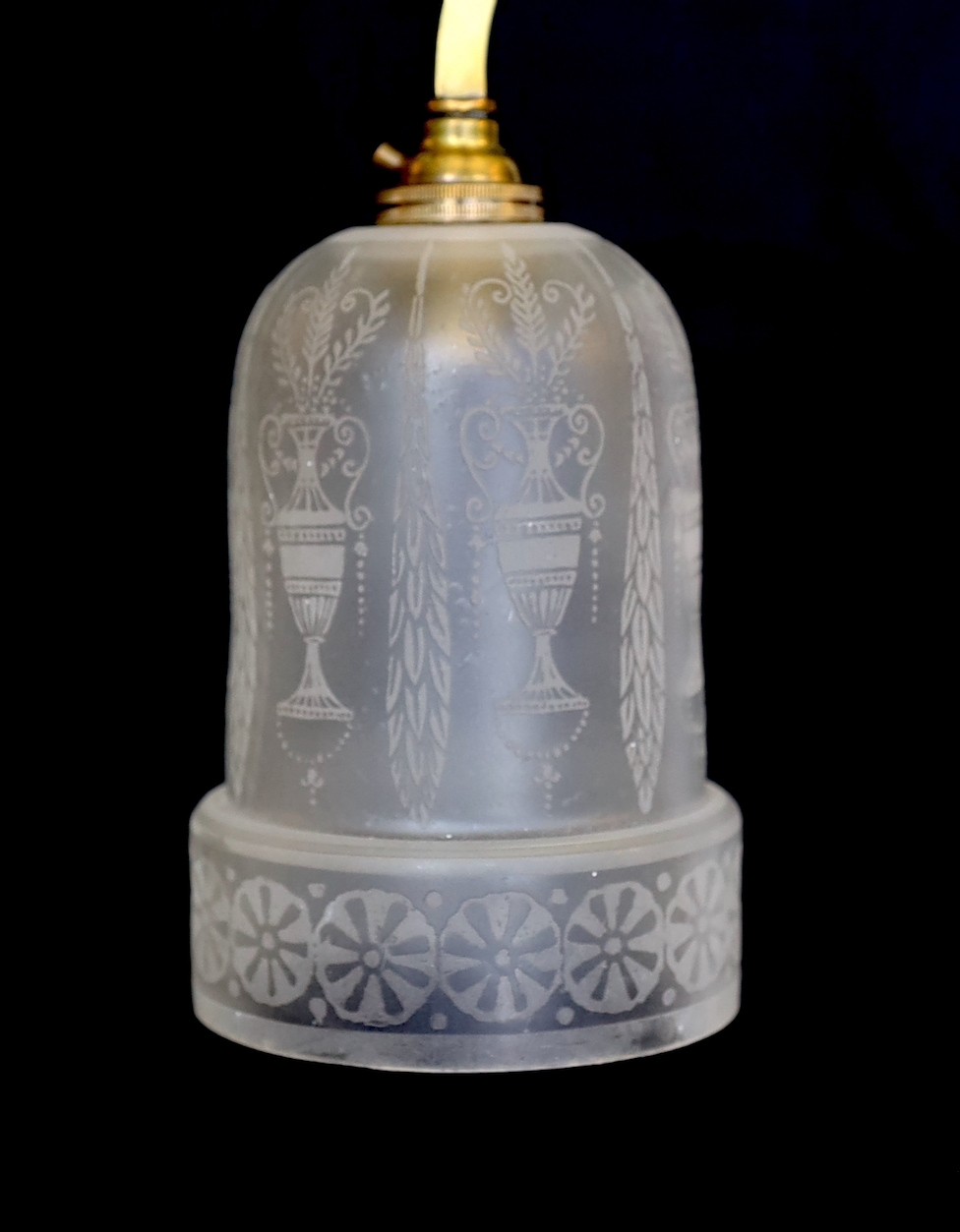 An Edwardian brass counter balanced light fitting with frosted glass shades etched with Grecian urns, height 80cm. width 64 cm